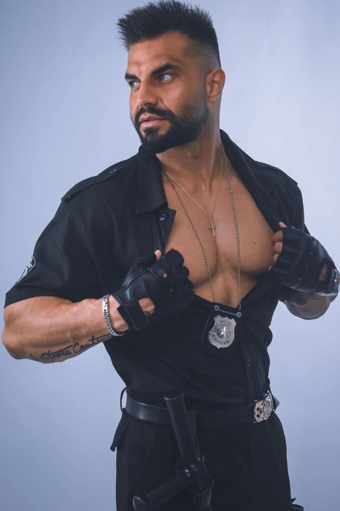 striptizer w stroju policjanta z rozpięta koszulą na panieńskie